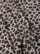 Load image into Gallery viewer, Close-up of fabric with a floral print pattern on a beige background